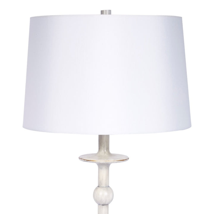 Brushed silver table lamp with white drum shade and round base