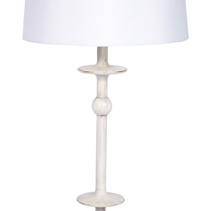 Brushed silver table lamp with white drum shade, slender column and mid ring
