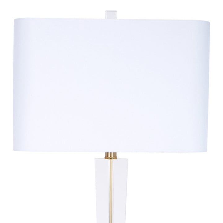 White linen crystal table lamp with cylindrical shade and brass-toned stem