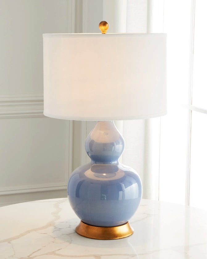 Stylish Parisian blue porcelain lamp with linen shade, adding a pop of color and modern elegance to any room.