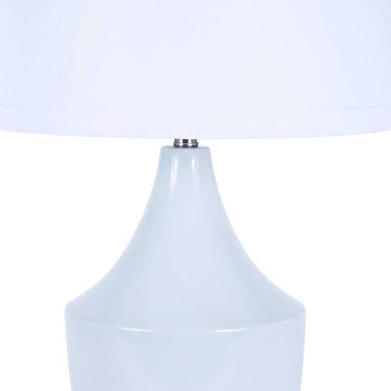 Blue ceramic table lamp with white fabric shade and rounded base