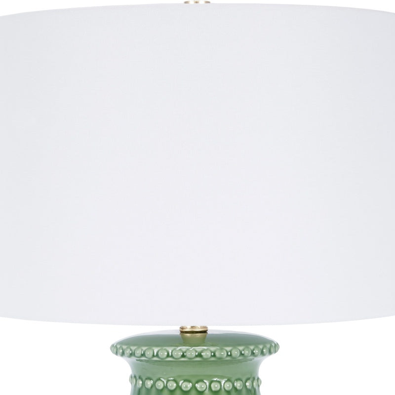 Green ceramic table lamp with white drum shade and beaded stud accents