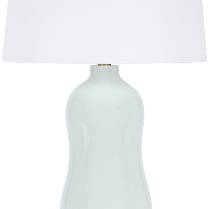 Ceramic table lamp in mint green with white drum shade and brass socket