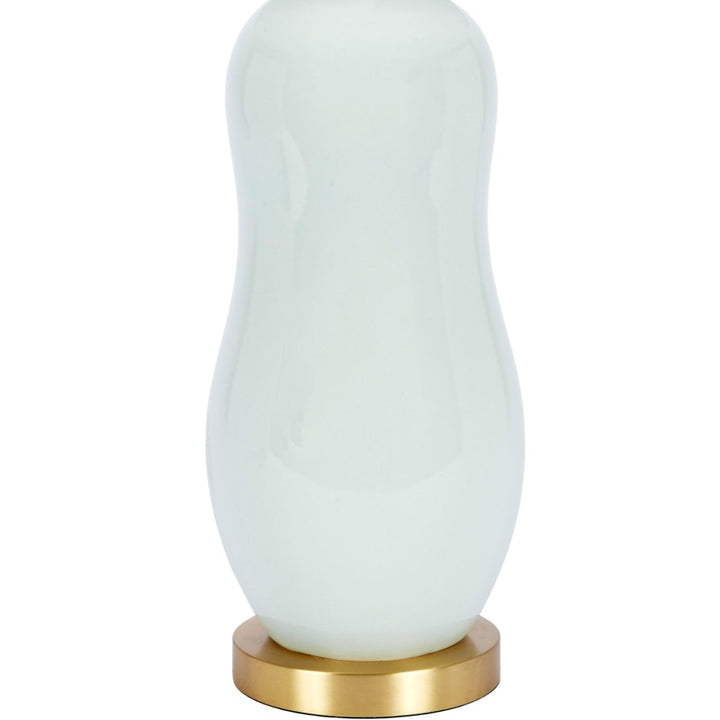 Mint green ceramic table lamp with white drum shade and brass base ring
