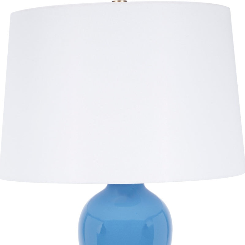 Ceramic table lamp with white fabric shade and blue glossy base