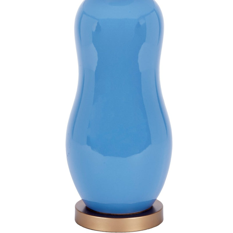 Ceramic table lamp with blue glossy ceramic base and brass-toned base ring