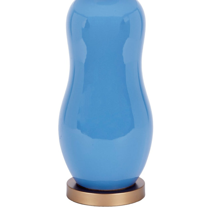 Ceramic table lamp with blue glossy ceramic base and brass-toned base ring