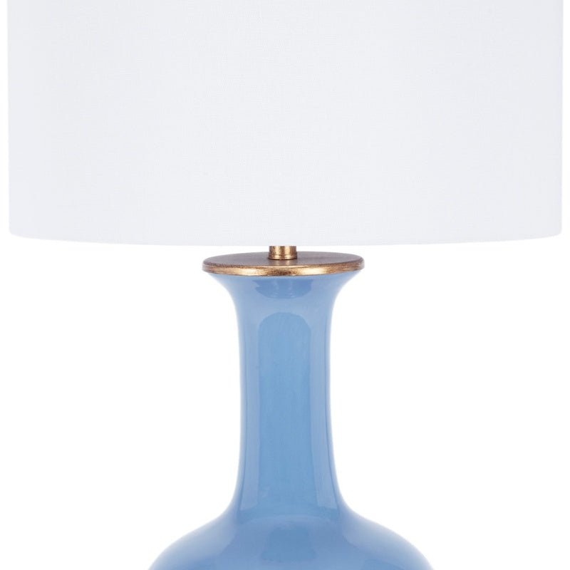Blue ceramic table lamp with white fabric shade and brass cap detail