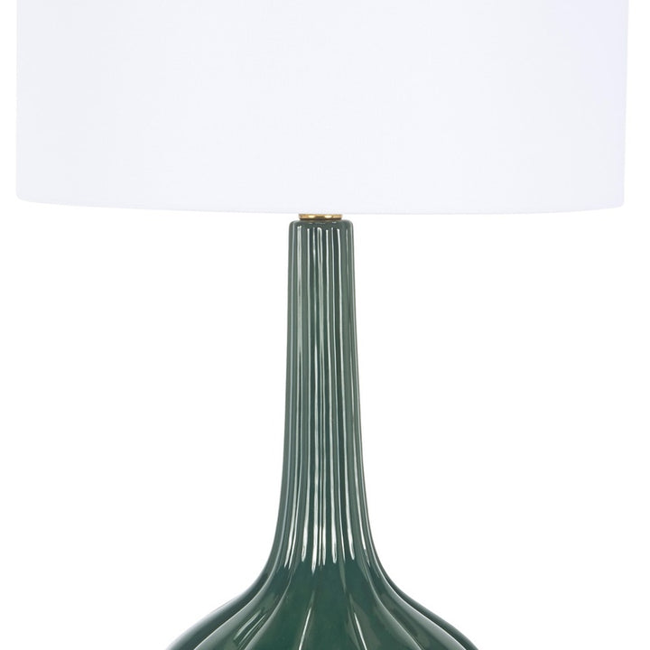 Dark green table lamp with white drum shade and tall ribbed column base