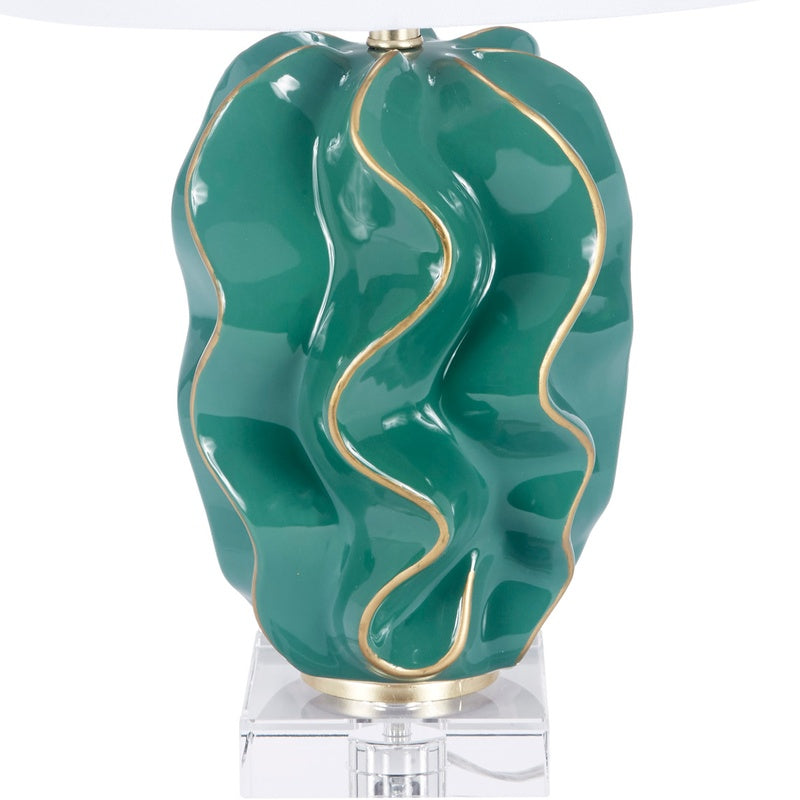 Emerald green ceramic wave lamp on clear stand with white fabric shade