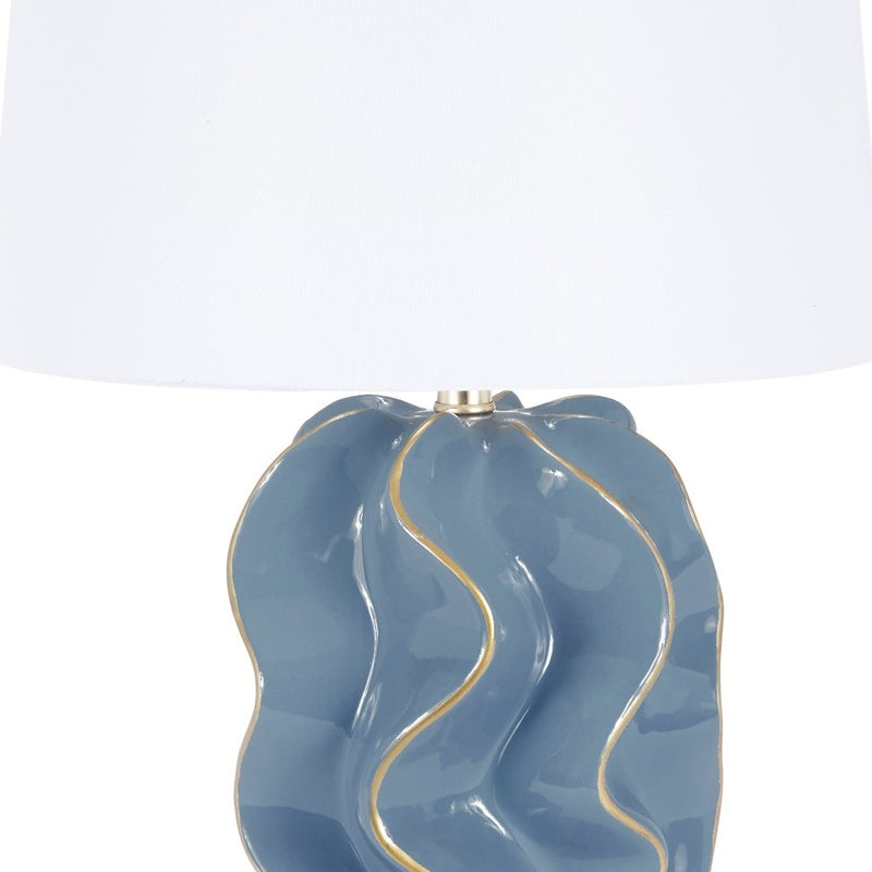 Blue wavy ceramic lamp base with gold socket and white drum shade