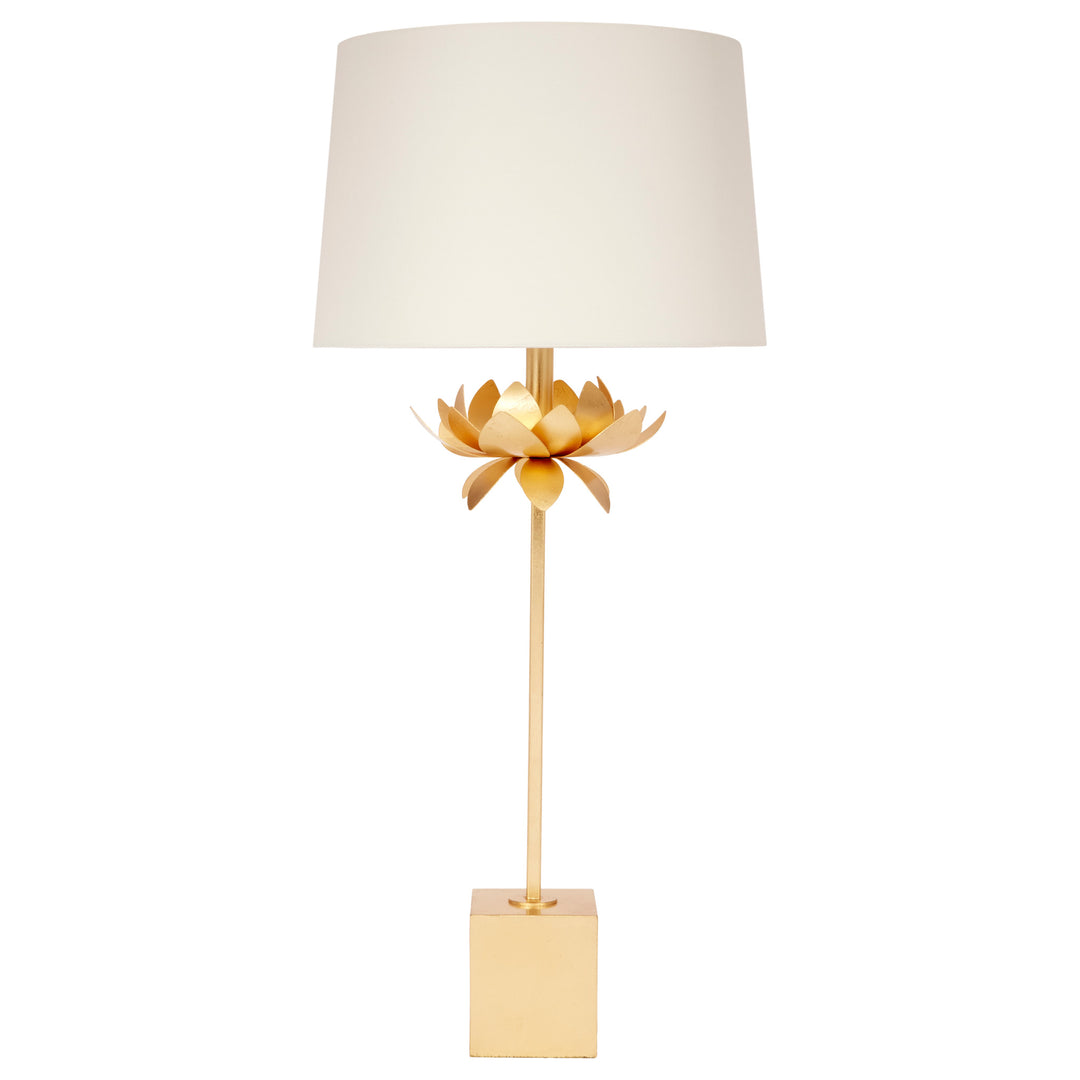 Decorative table lamp with gold base and white shade on a white background
