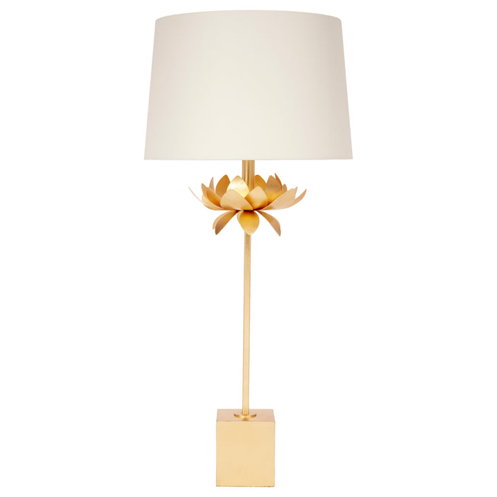 Decorative table lamp with gold base and white shade on a white background