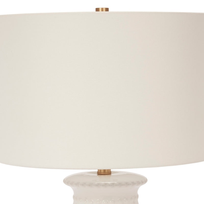 Ceramic table lamp with white fabric shade and white beaded base, brass neck