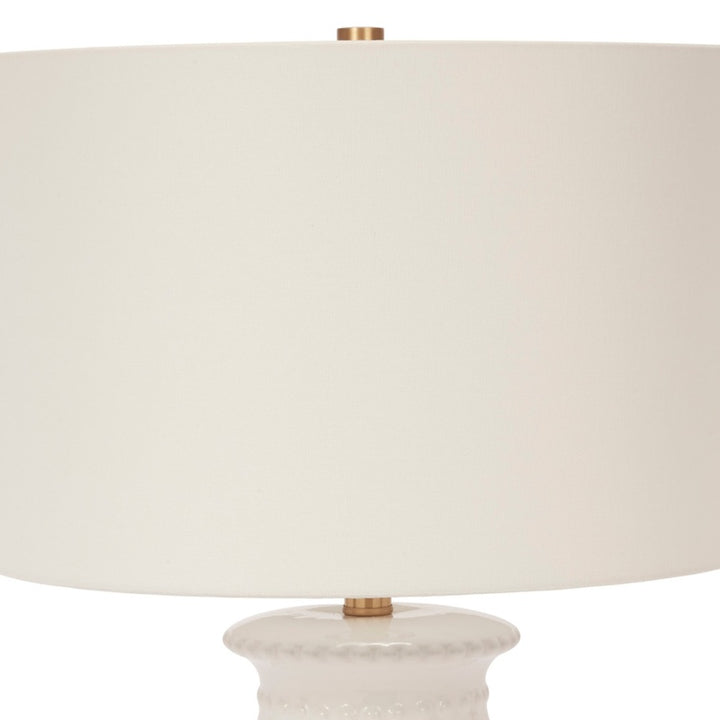 Ceramic table lamp with white fabric shade and white beaded base, brass neck