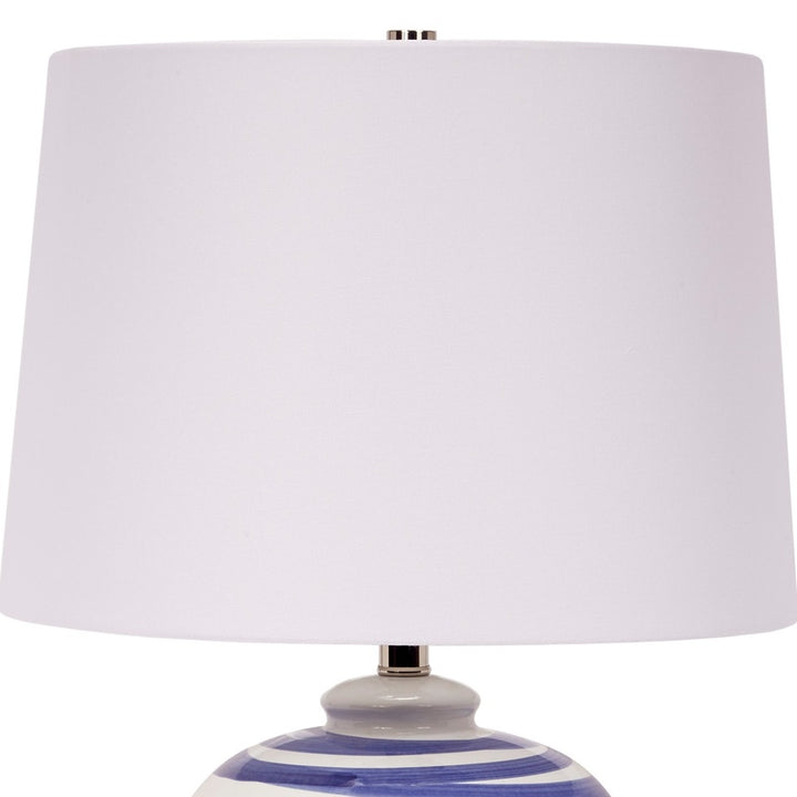 Ceramic table lamp with blue striped base and white drum shade