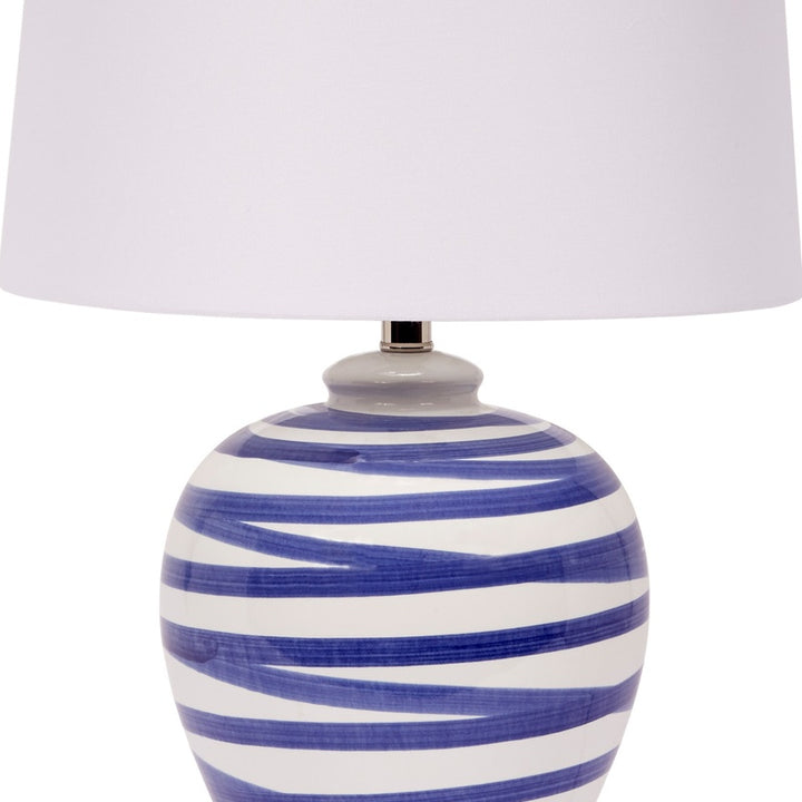 Blue striped ceramic table lamp base with white drum shade