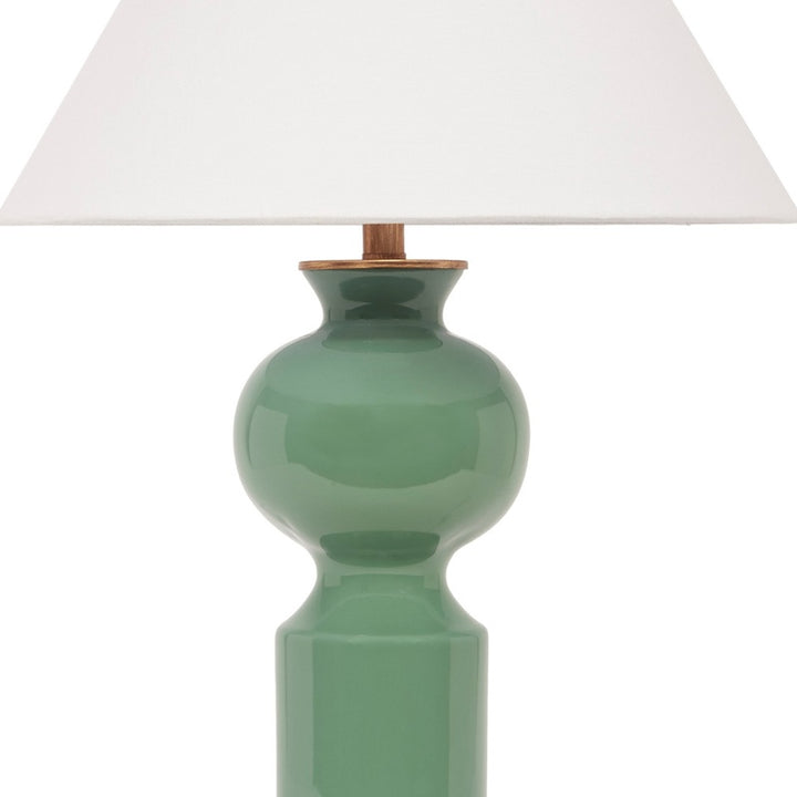 Green ceramic table lamp base with brass socket and white linen shade