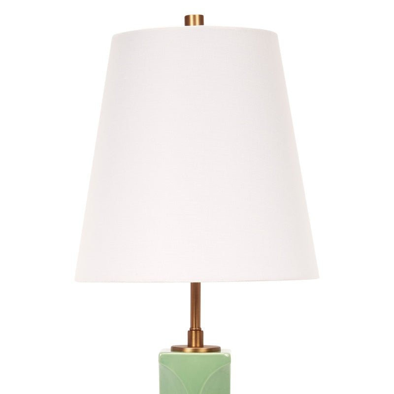 Green ceramic table lamp with white linen drum shade and brass base