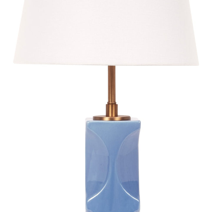 Blue ceramic table lamp base with brass neck and white linen shade