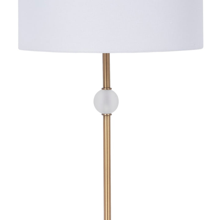 White drum shade table lamp with brass pole and round white collar