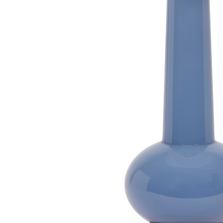 Close-up of blue ceramic lamp body with glossy finish above the base