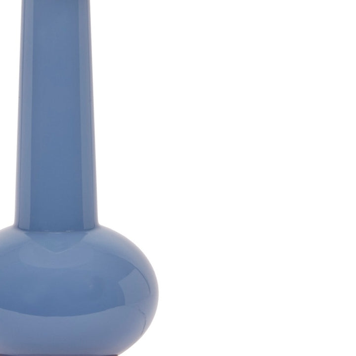 Close-up of glossy blue ceramic lamp body and flared neck