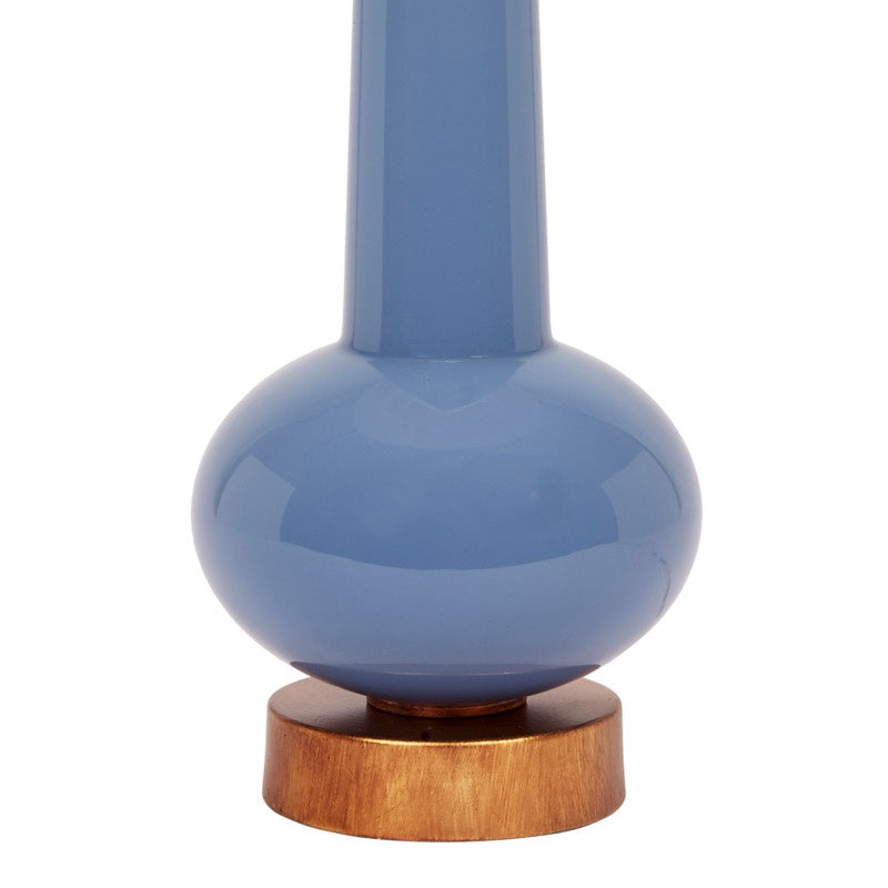 Blue ceramic buffet lamp with white linen shade, brass ring, and wooden base