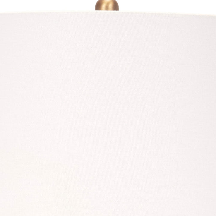 Ceramic table lamp with off-white shade and brass top
