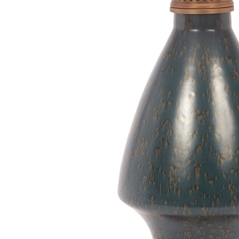 Blue ceramic lamp base with gold fleck texture and curved silhouette