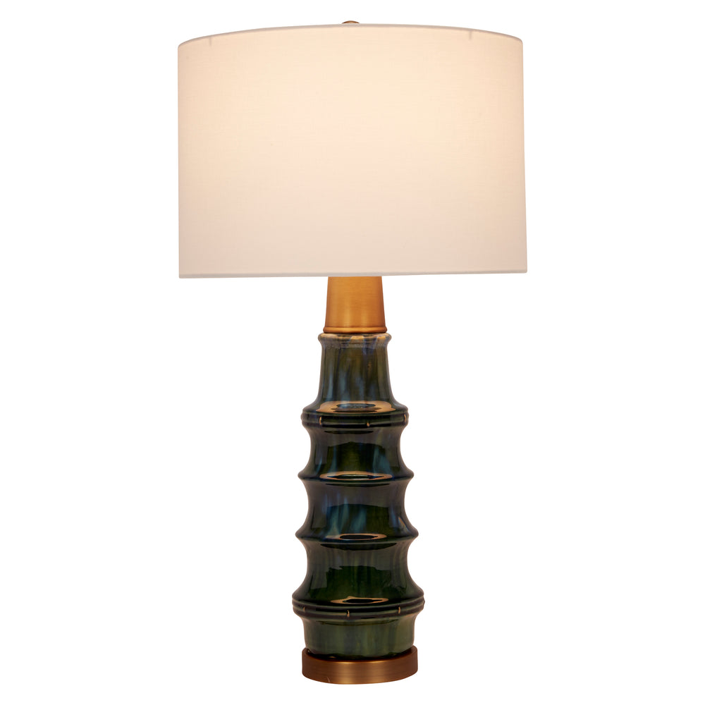 Stylish peacock green ceramic lamp with brass details, adding a pop of color and luxurious charm to any room.