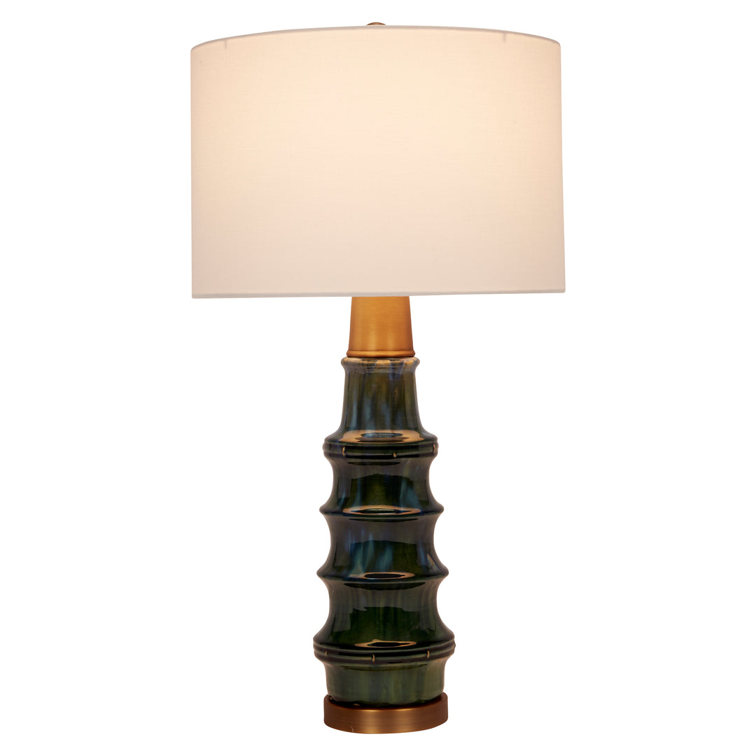 Stylish peacock green ceramic lamp with brass details, adding a pop of color and luxurious charm to any room.