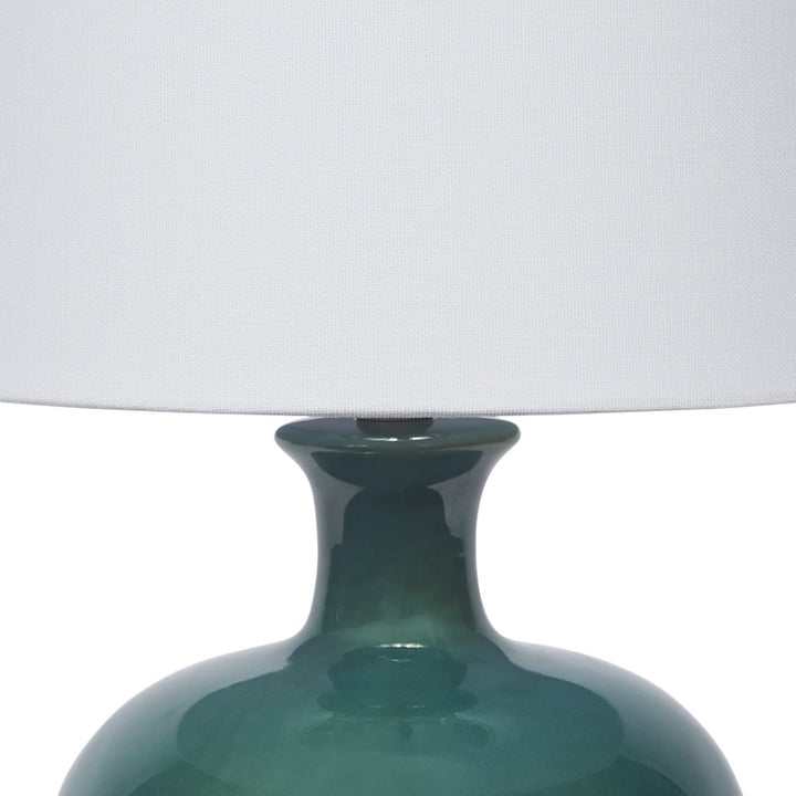 Dark green ceramic table lamp with white drum shade