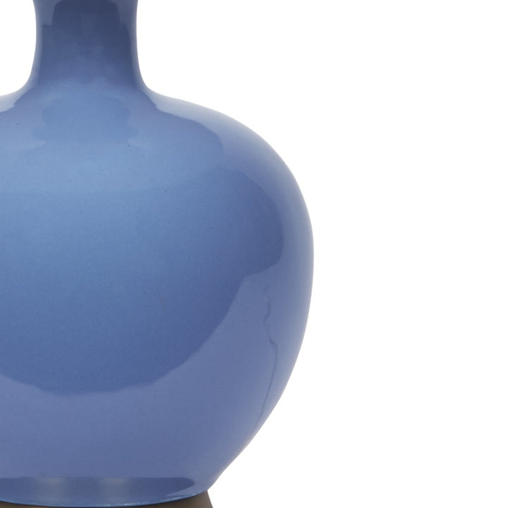 Dark blue ceramic lamp body, glossy finish and rounded silhouette