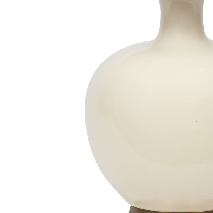 Cream ceramic globe-shaped table lamp body, close-up