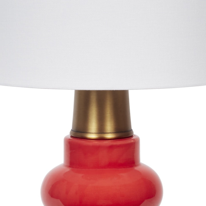 Red ceramic lamp body with brass neck and white fabric lampshade