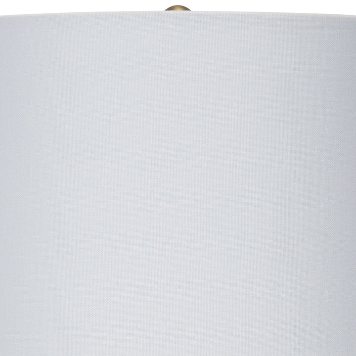 Ceramic table lamp with white drum lampshade and brass finial