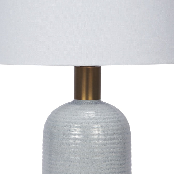 Light blue textured ceramic table lamp with brass neck and base collar