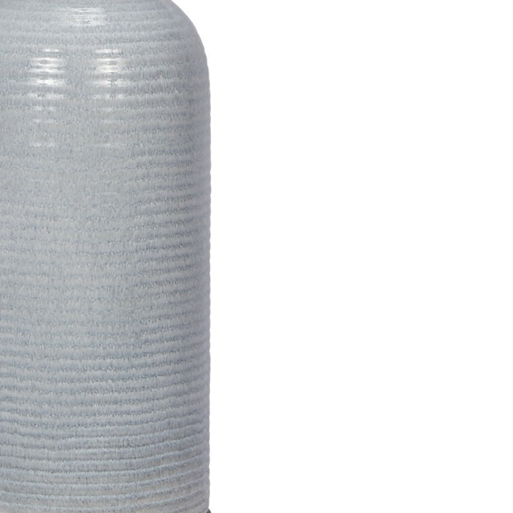 Light blue ribbed ceramic lamp body close-up