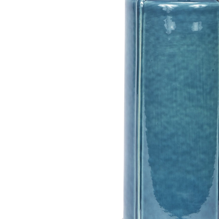 Teal ceramic lamp body with glossy finish and vertical seam