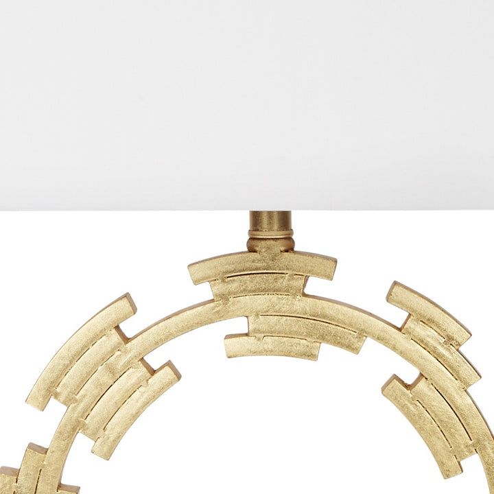 Gold metal circular ring frame detail under white lamp shade