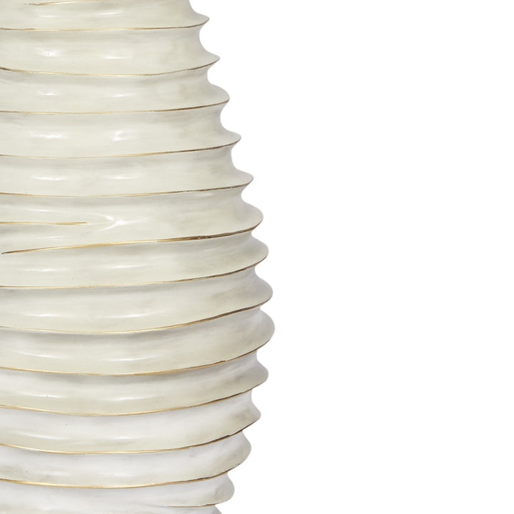 Close-up of cream lamp base ridges with thin gold lines