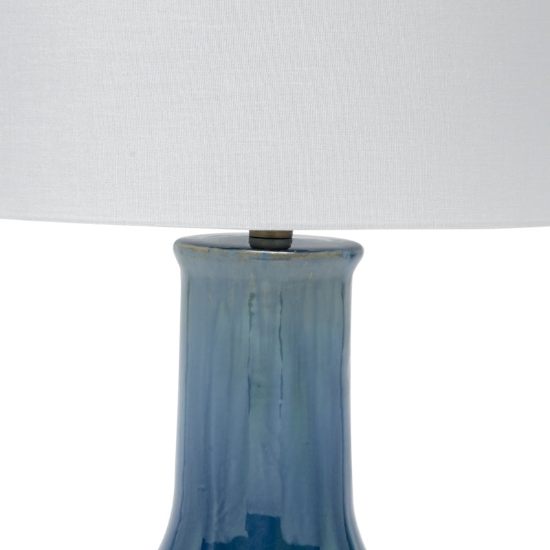 Lamp with off-white drum shade and glossy blue ceramic column base top
