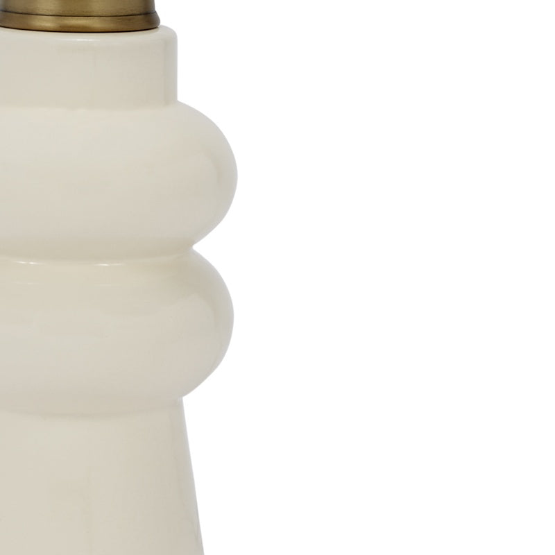 Cream ceramic lamp base close-up with stepped collar and brass neck cap