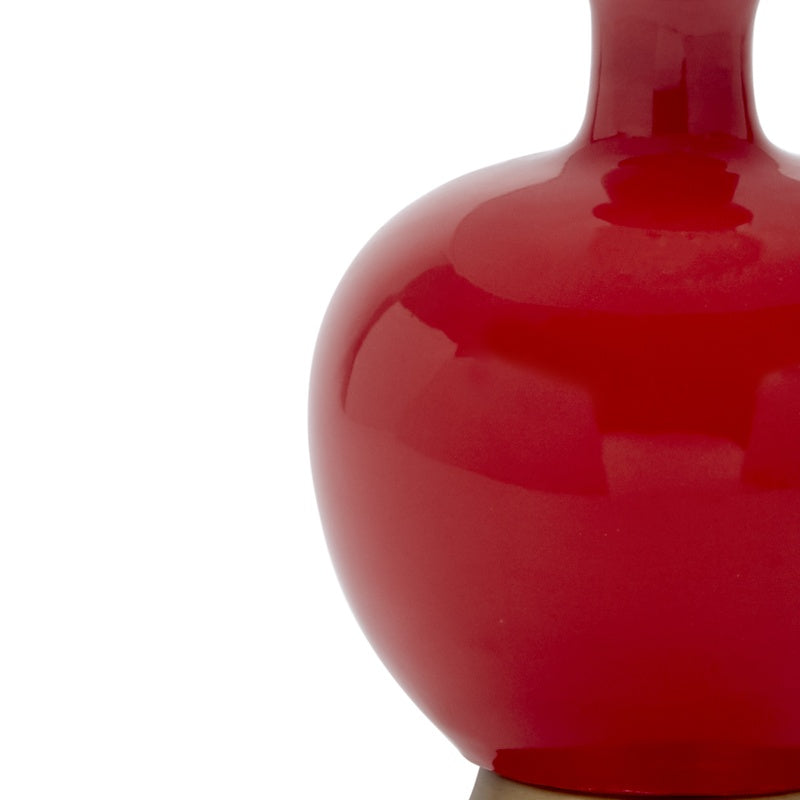 Red glossy ceramic table lamp body, curved round side detail close-up