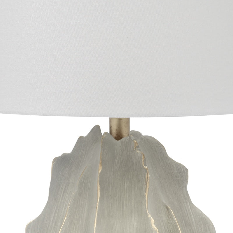 Gray cement lamp base with gold accents and white linen shade top