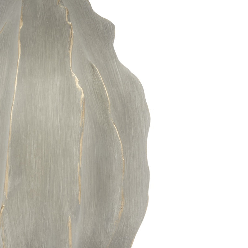 Close-up of textured gray cement lamp base with gold vein lines