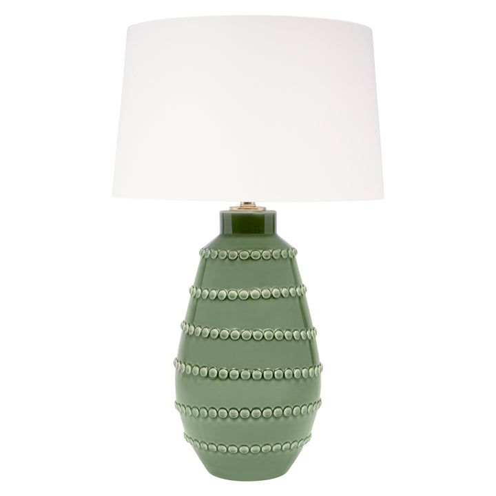 Large green ceramic table lamp with white linen drum shade and beaded ring base.