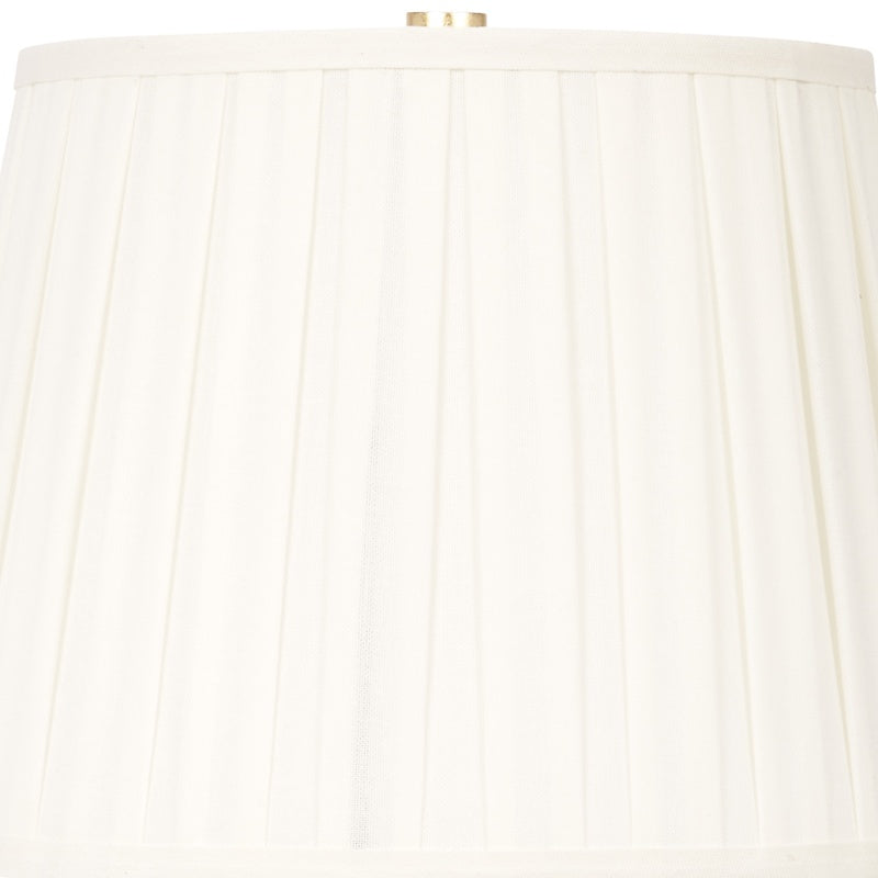 White pleated lamp shade with fabric ridges and gold finial cap