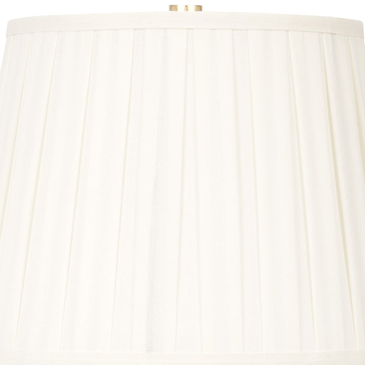 White pleated lamp shade with fabric ridges and gold finial cap